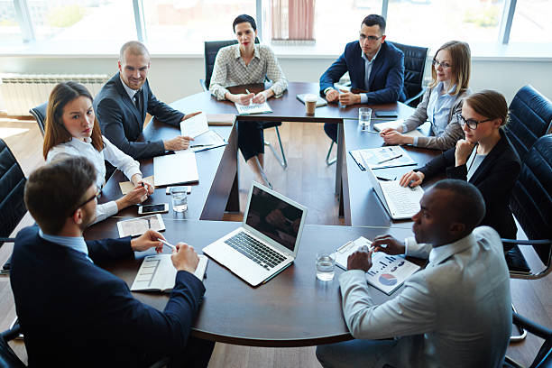 businespeople at panel discussion in board room